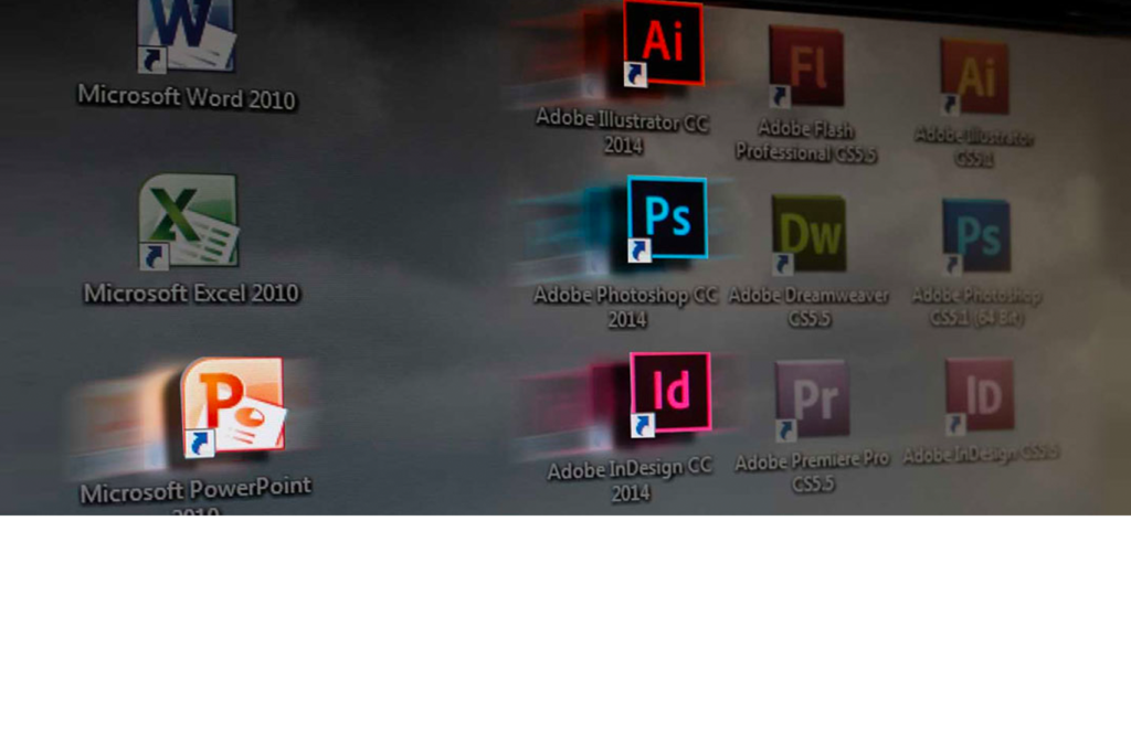 Nahaufnahme eines Computerbildschirms mit Anwendungssymbolen. Zu den hervorgehobenen Symbolen gehören Microsoft Word, Excel und PowerPoint 2010 sowie Produkte der Adobe Creative Suite wie Illustrator, Photoshop, Dreamweaver, InDesign und Premiere Pro mit den Versionsjahren.